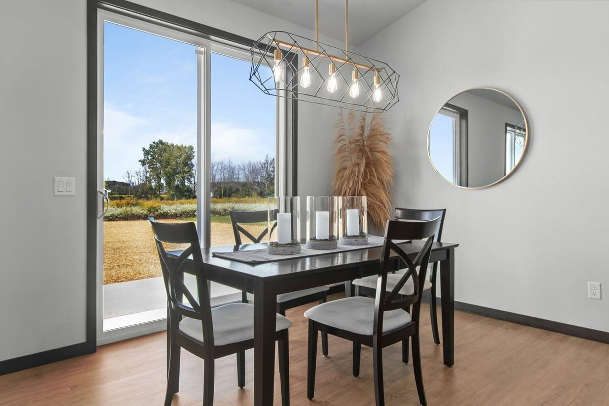 Dining area with large sliding glass doors in custom home by Midwest Design Homes in Ellington, WI