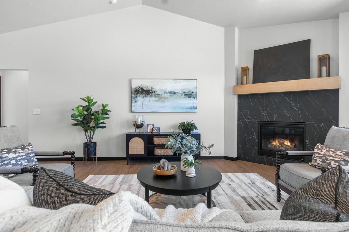 Living room with fireplace and artwork in custom home by Midwest Design Homes in Bellevue, WI