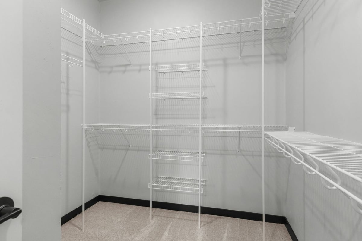 Spacious walk-in closet with shelving in custom home by Midwest Design Homes in Bellevue, WI