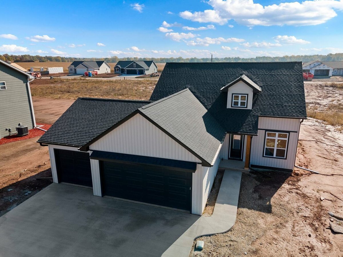 Aerial shot of modern Wisconsin custom home construction in progress by Midwest Design Homes.