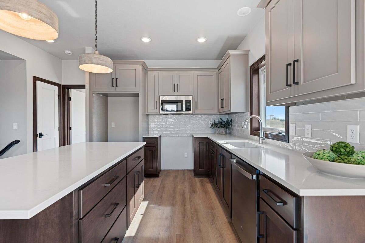 Close-up of kitchen layout with microwave and double-sink in a Wisconsin home by Midwest Design Homes.