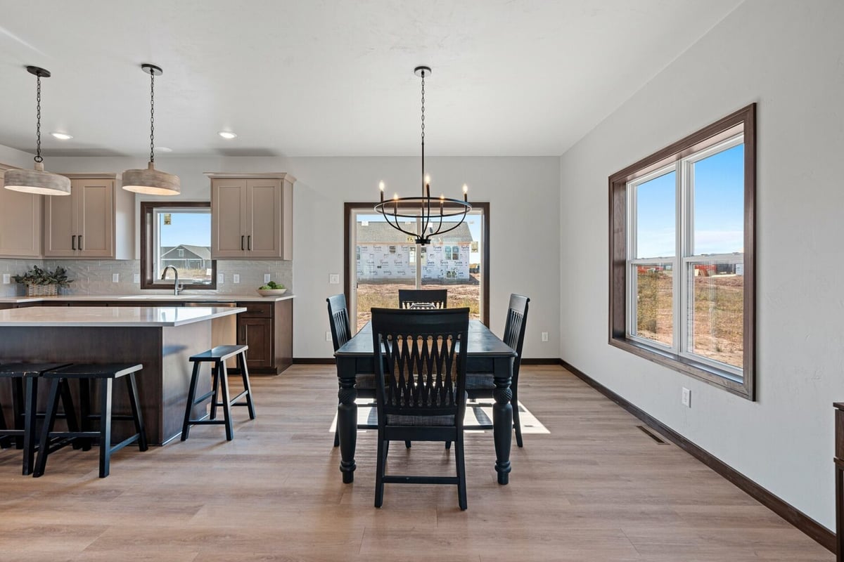 Modern dining area connected to kitchen in a custom-built home by Midwest Design Homes in Harrison, Wisconsin.