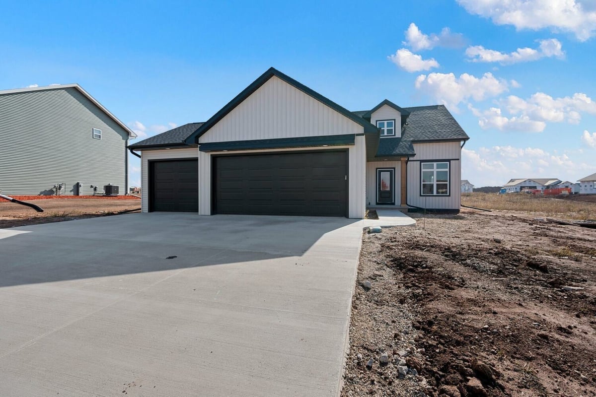 Spacious concrete driveway leading to a new custom home by Midwest Design Homes in De Pere, WI.