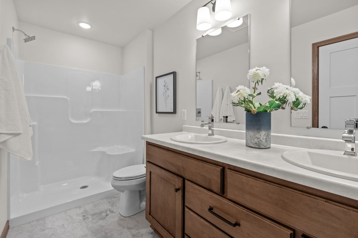 Modern bathroom with double-sink vanity, walk-in shower, and neutral finishes, located in the Fox Cities