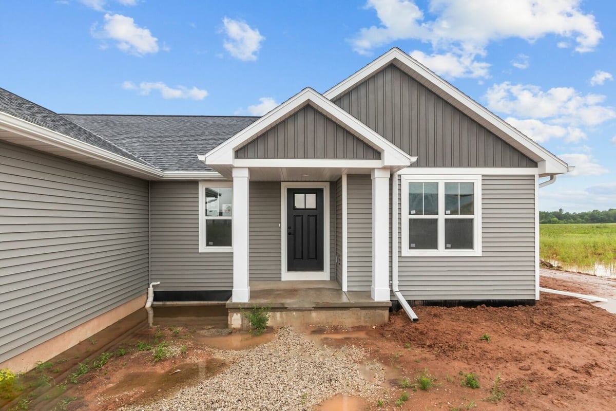 Covered entryway of a gray custom home build by Midwest Design Homes in Fox Cities, WI