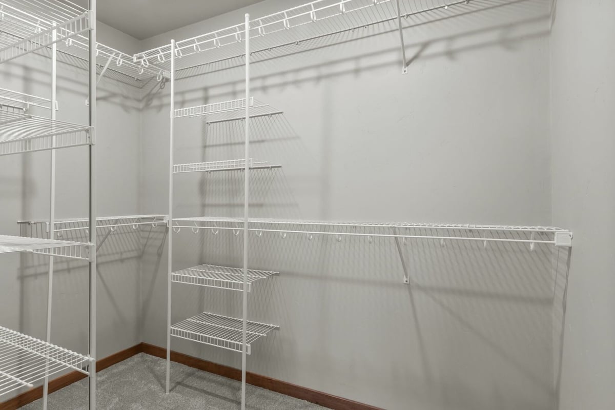 Custom walk-in closet with built-in wire shelving by Midwest Design Homes in Harrison, WI