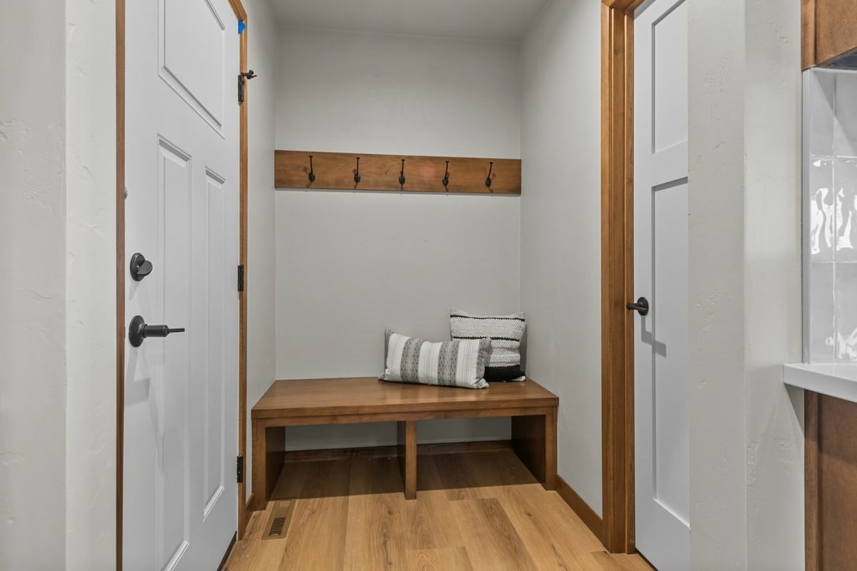 Mudroom entry with bench and hooks in custom home by Midwest Design Homes in Appleton, WI