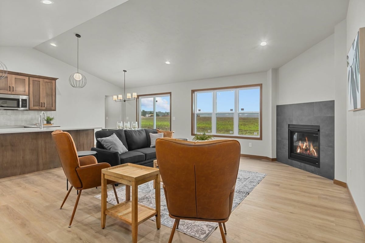 Spacious great room with modern fireplace and open layout by Midwest Design Homes in Bellevue, WI