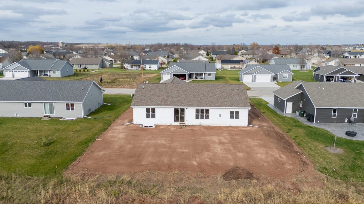 Aerial view of new home build showing full lot and surrounding neighborhood by Midwest Design Homes in Bellevue, WI