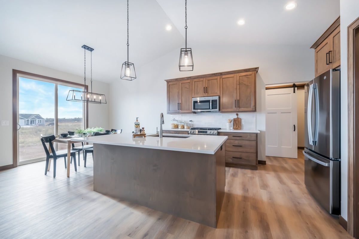 Kitchen with island and dining space in a custom home by Midwest Design Homes in Kaukauna, WI