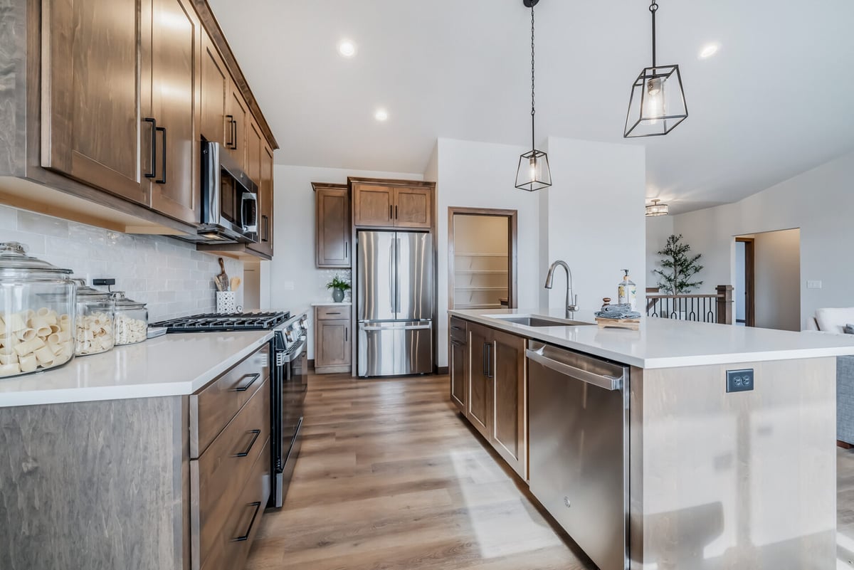 Kitchen workspace with pendant lighting and stainless appliances in a Wisconsin home by Midwest Design Homes