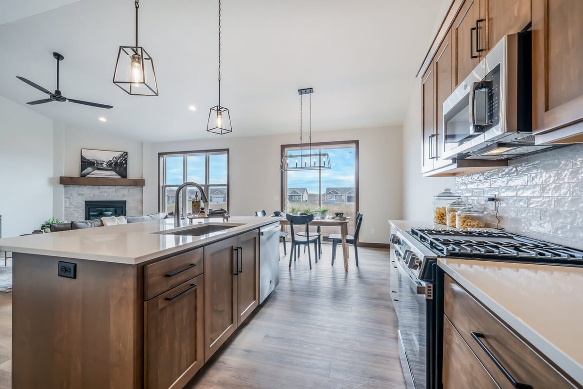 View from kitchen island to dining area and living room in a custom Midwest Design Homes build in Wisconsin