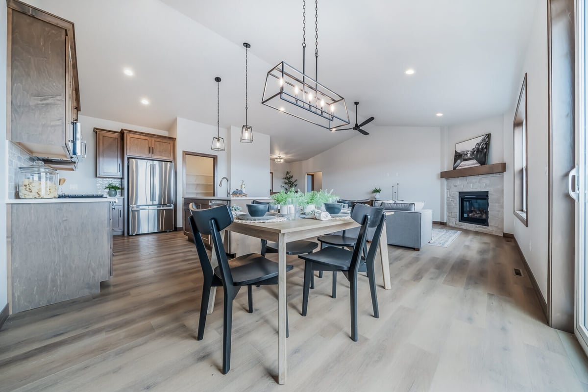 View of open kitchen and dining area in a custom Kaukauna, WI home by Midwest Design Homes