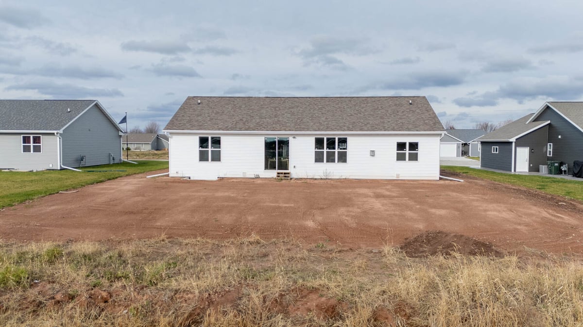 Wide-angle rear view of completed custom home construction by Midwest Design Homes in Green Bay, WI