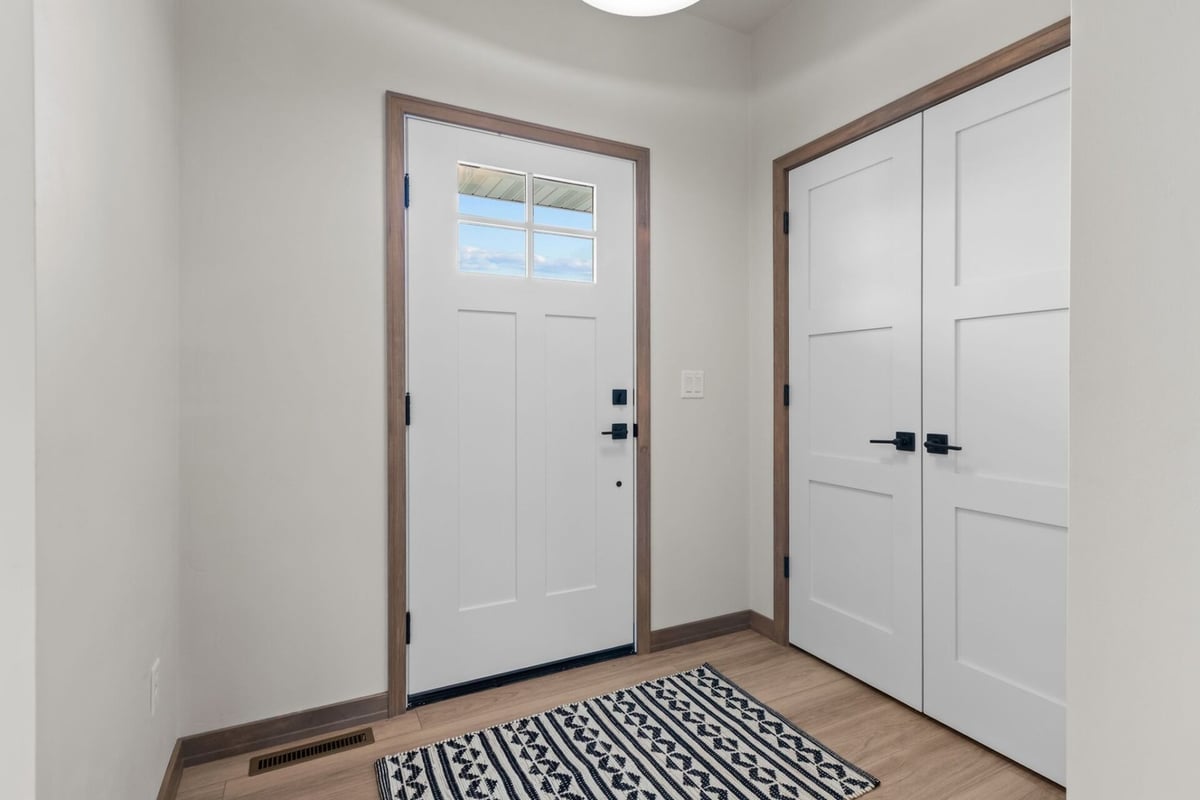 Bright entryway with white front door and double closets in a Midwest Design Homes build in Kaukauna, WI