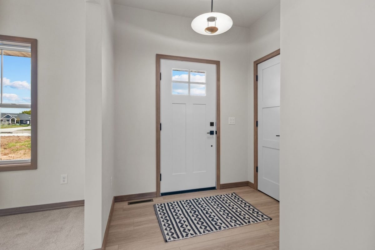 Custom home entryway with front door and window view built by Midwest Design Homes in Kaukauna, WI