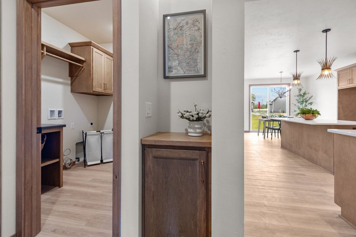 Hallway view into laundry and kitchen areas in a custom Kaukauna, WI home by Midwest Design Homes