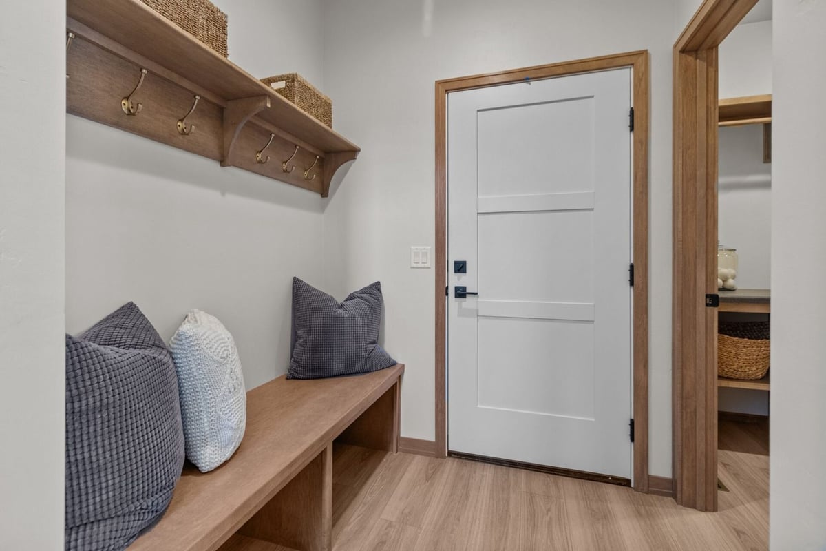 Mudroom with built-in bench, cubbies, and hooks in a custom home by Midwest Design Homes in Kaukauna, WI