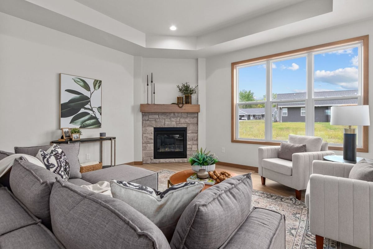 Natural light fills the living space with modern furnishings in this custom build by Midwest Design Homes in Fremont, WI