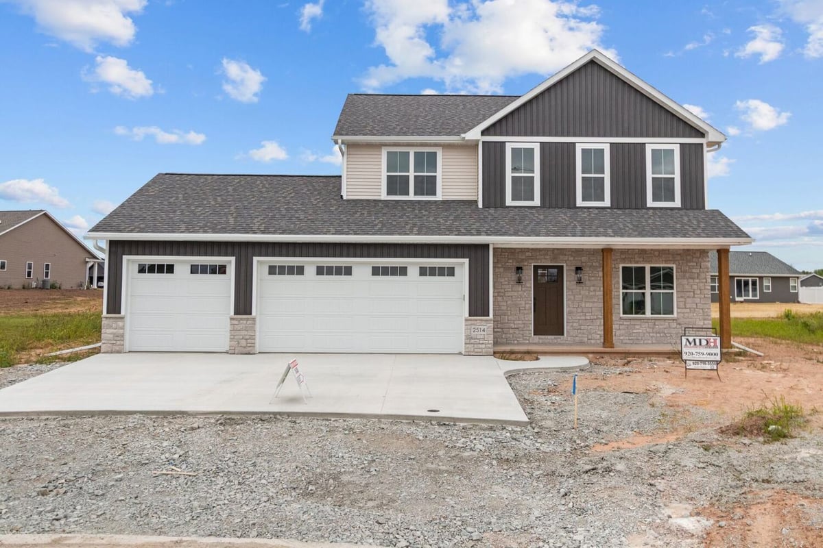 Two-story custom home exterior with three-car garage by Midwest Design Homes in Kaukauna, WI