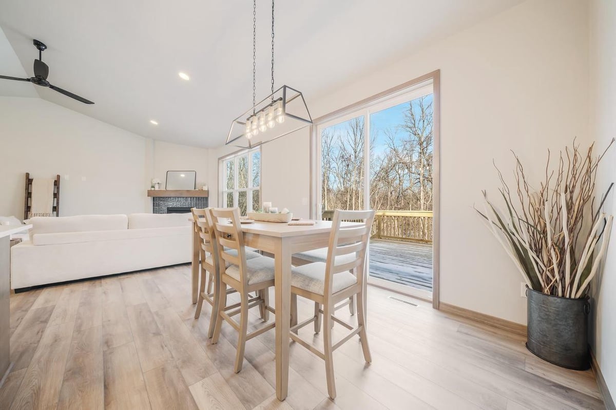 Dining area with high table, large windows, and deck access in the Fox Cities