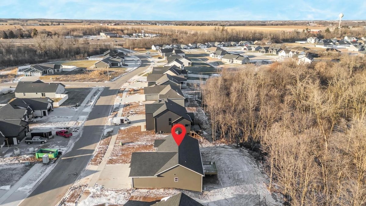 Drone view of Fox Cities home backing to trees, neighborhood and open land beyond