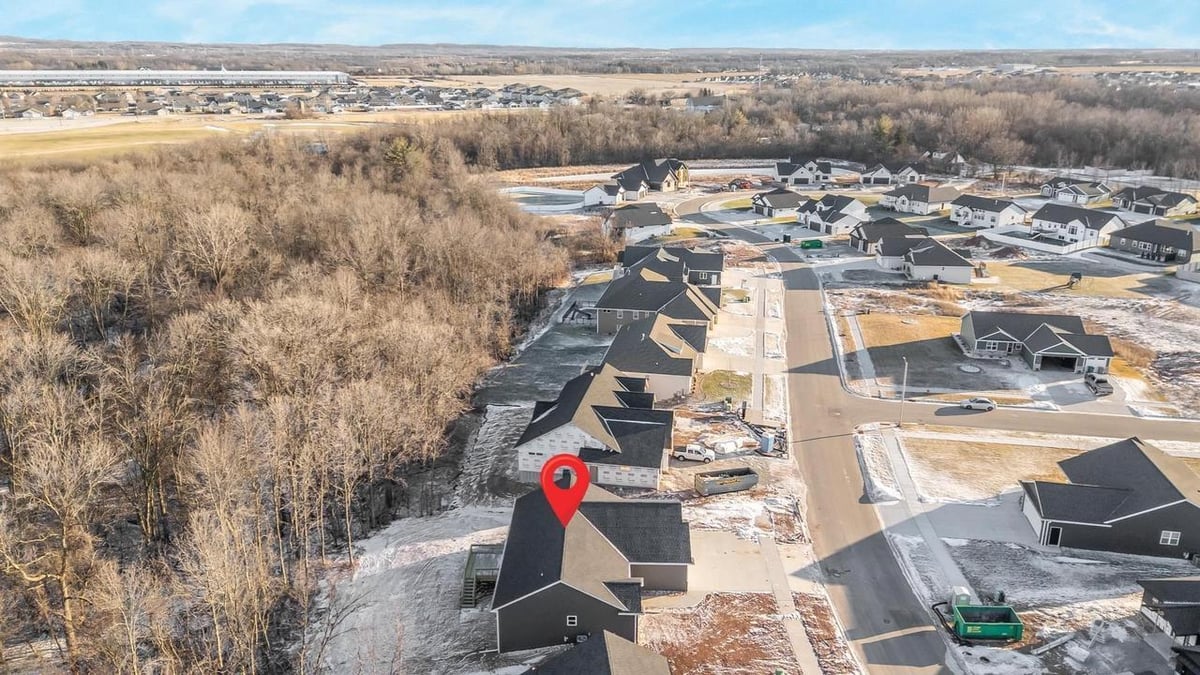 High aerial view of Fox Cities home and surrounding neighborhood near wooded area
