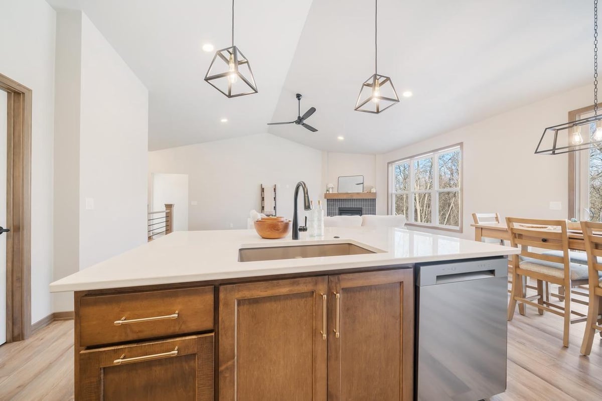 Modern kitchen island with quartz counters and pendant lights in the Fox Cities