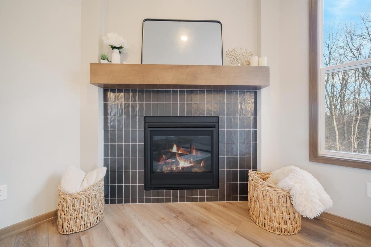 Modern tiled fireplace with wood mantel in the Fox Cities home