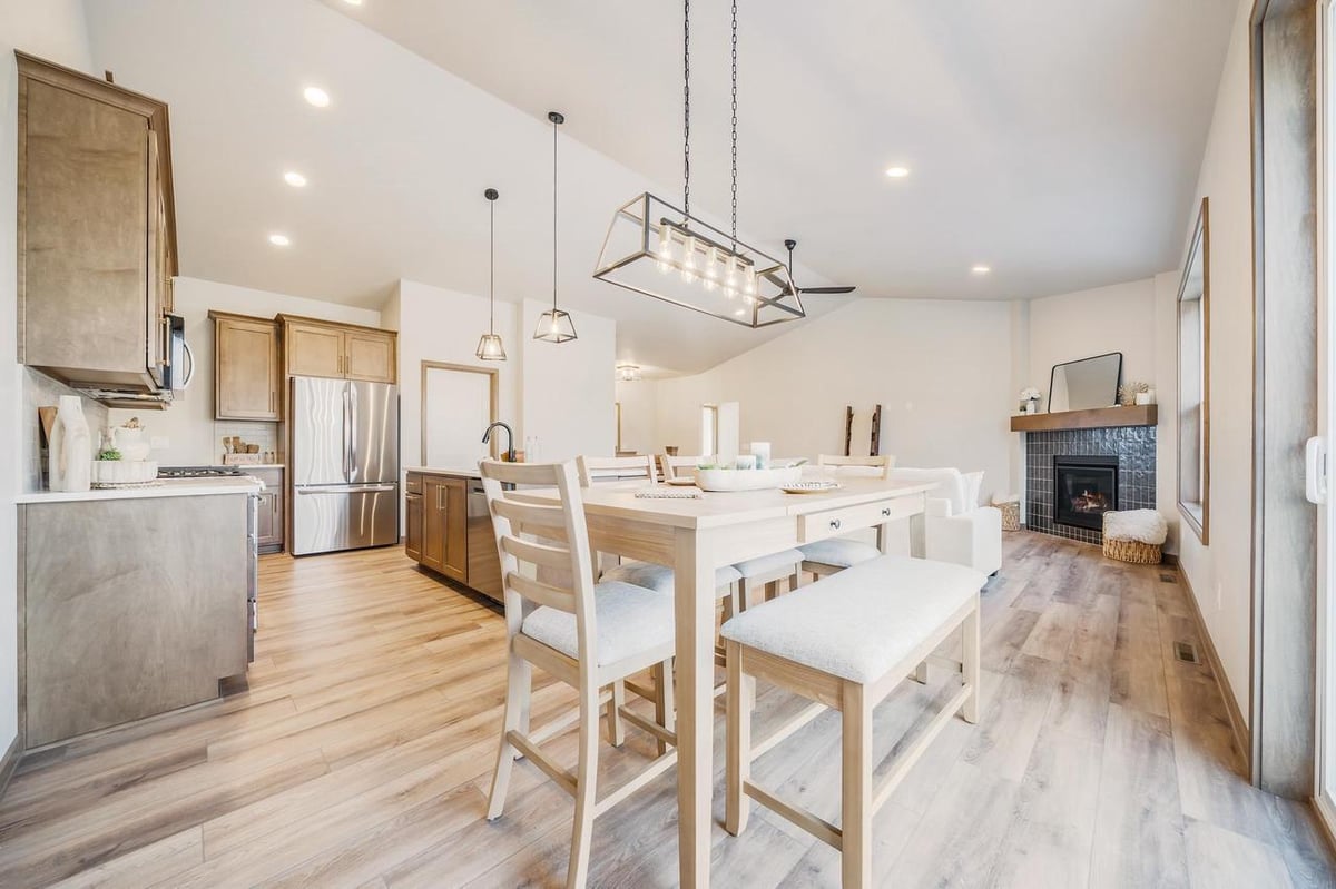 Open kitchen and dining space with fireplace and vaulted ceiling in the Fox Cities