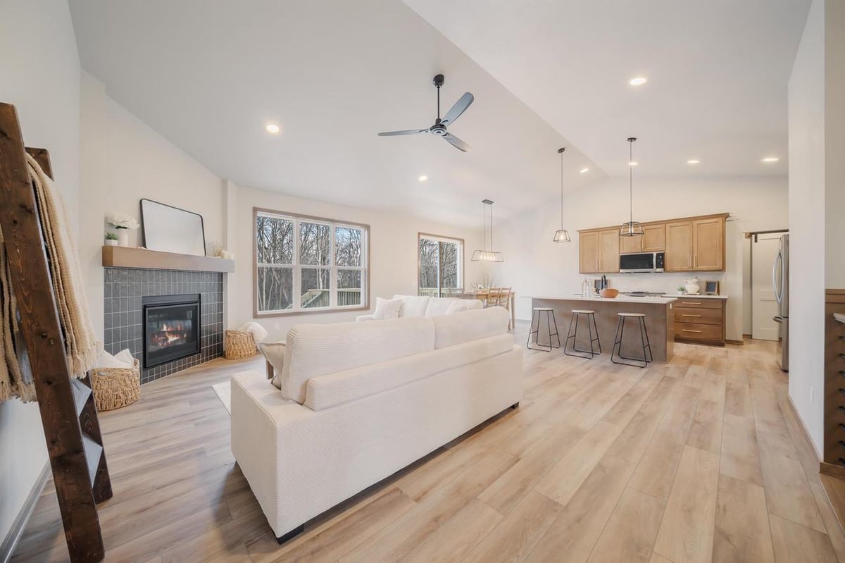 Open living space with vaulted ceiling and fireplace in a Fox Cities home