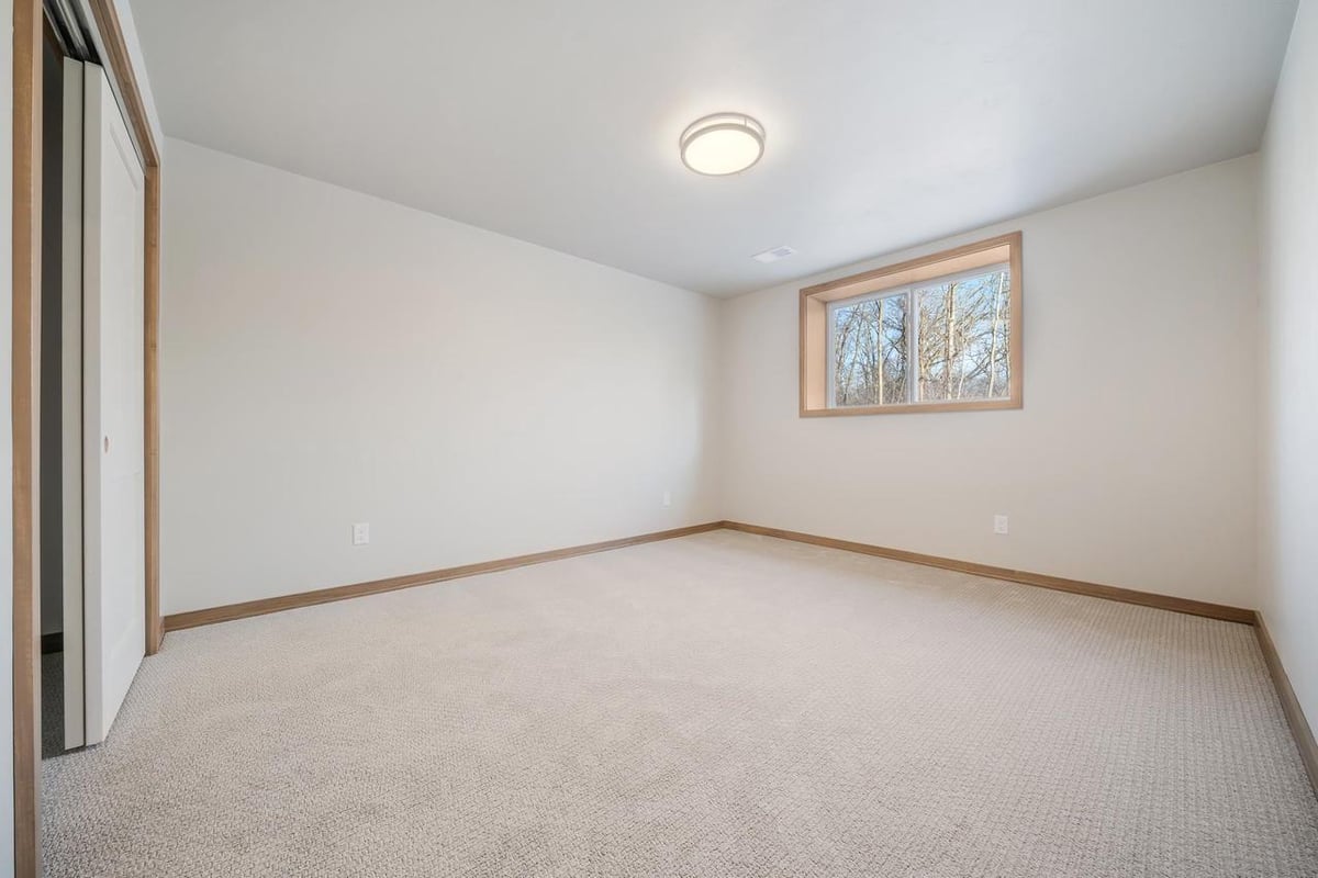 Spacious lower-level bedroom with egress window in the Fox Cities