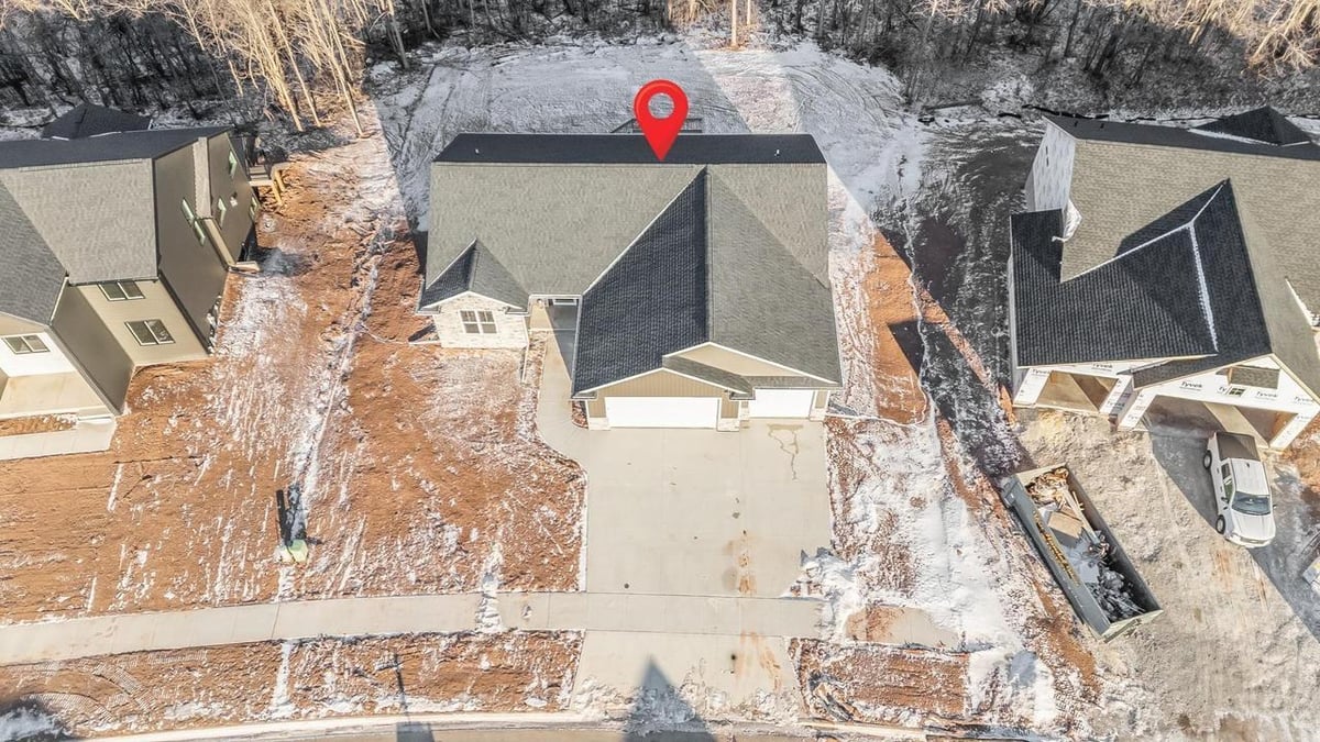 Top-down aerial of Fox Cities home showing driveway, rooflines, and lot layout