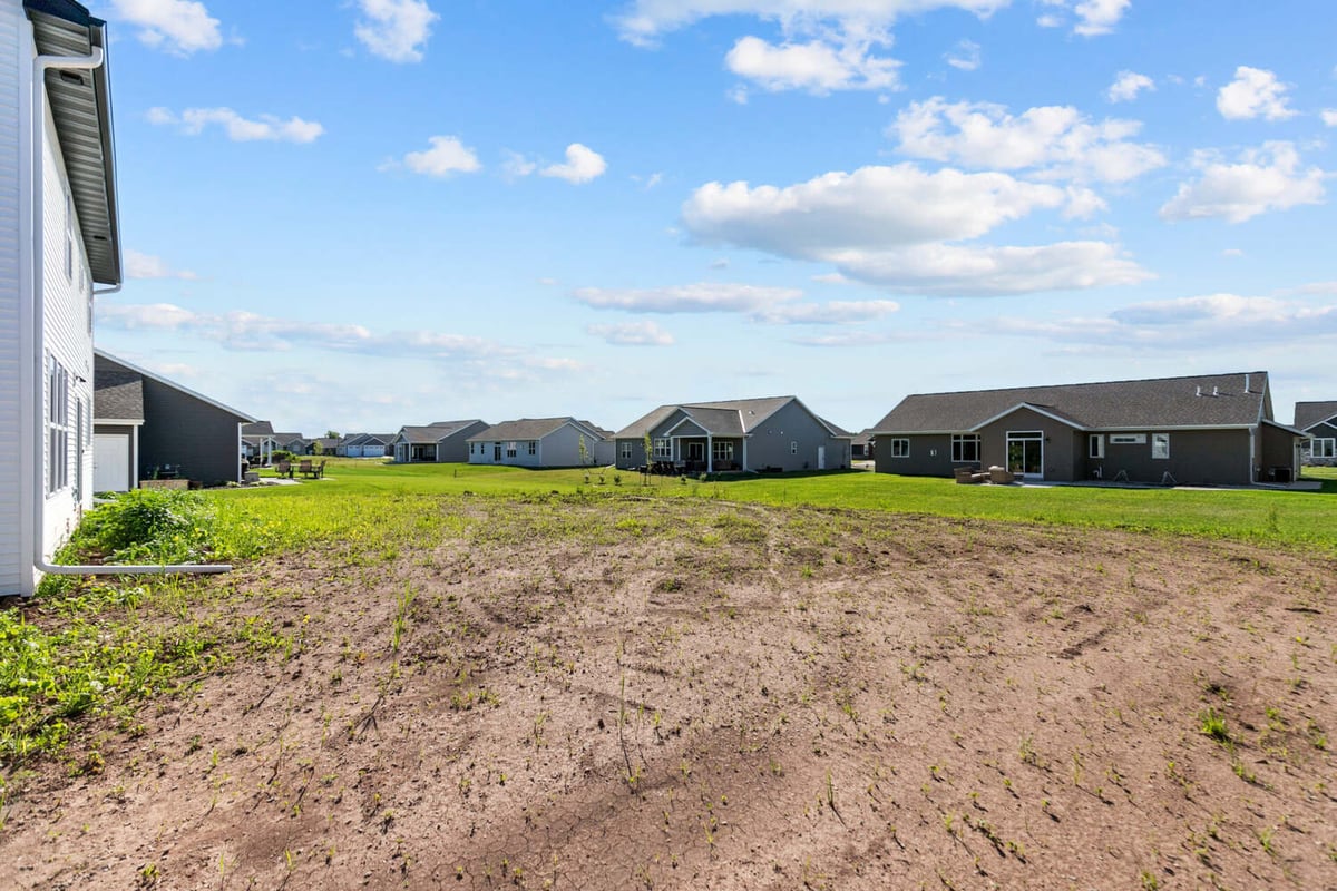 Backyard view of new custom homes in progress by Midwest Design Homes in Bellevue, WI