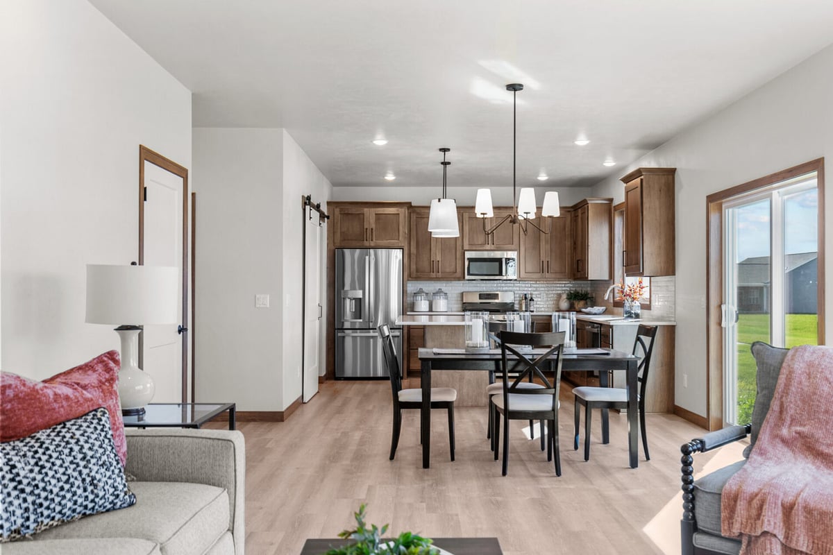 Bright kitchen-dining layout with large windows and natural light in Fox Cities, WI by Midwest Design Homes