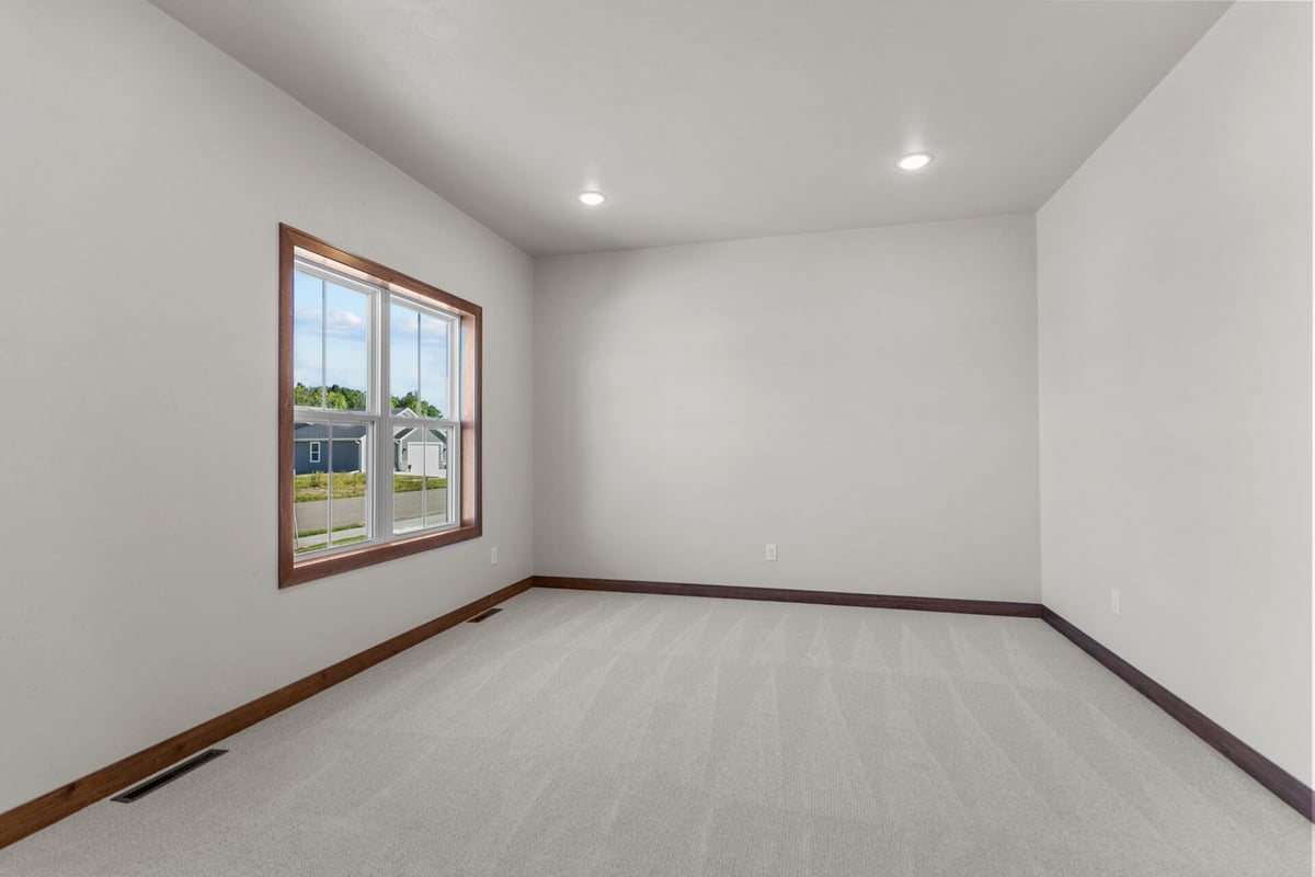 Carpeted bonus room in a new custom home in Neenah, Wisconsin by Midwest Design Homes