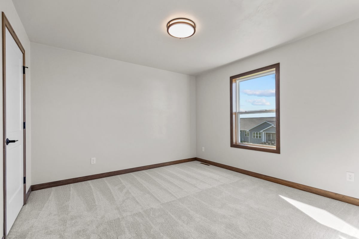 Custom home bedroom with natural light in Greenville, WI by Midwest Design Homes
