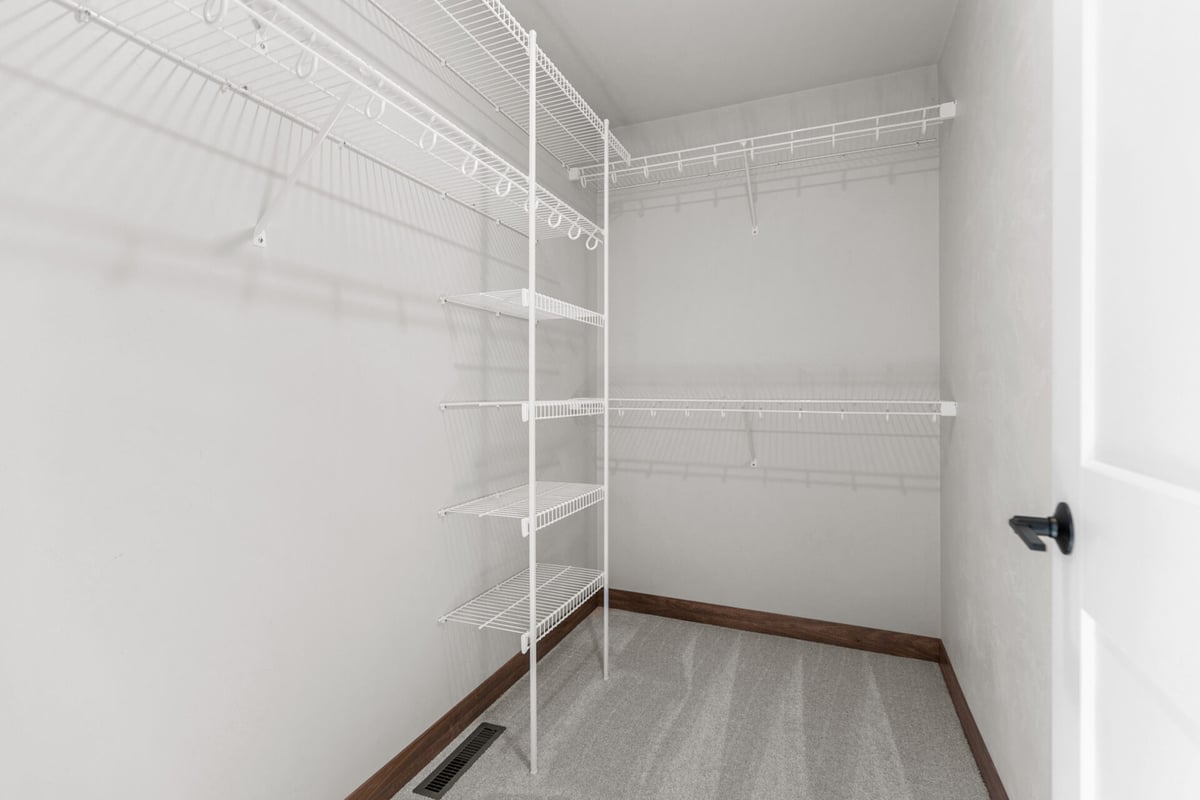 Spacious storage closet with built-in shelving system in Appleton, WI custom home by Midwest Design Homes