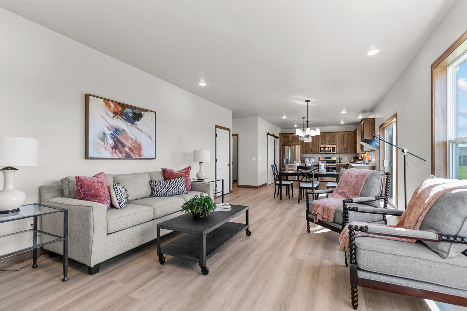 View of custom-built dining room flowing into cozy living room in Neenah, WI by Midwest Design Homes