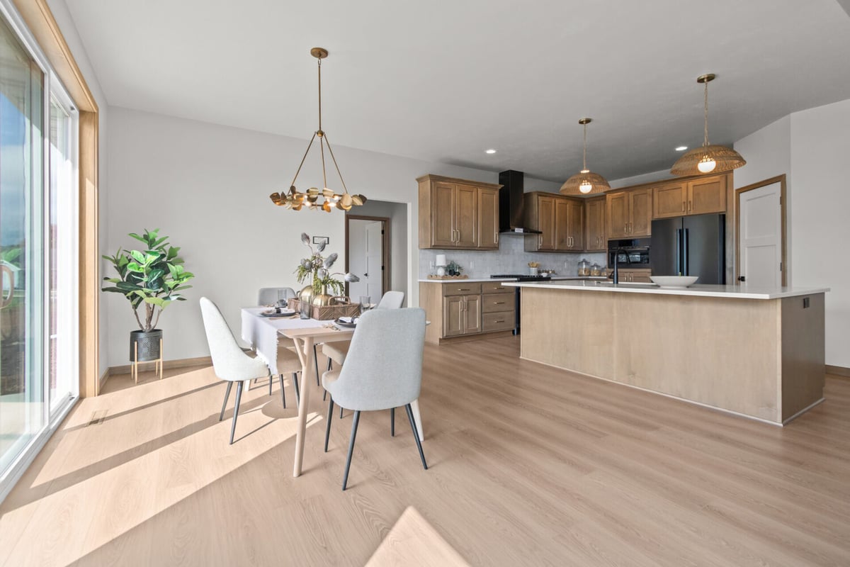 Combined kitchen and dining area in custom home by Midwest Design Homes in Fremont, WI