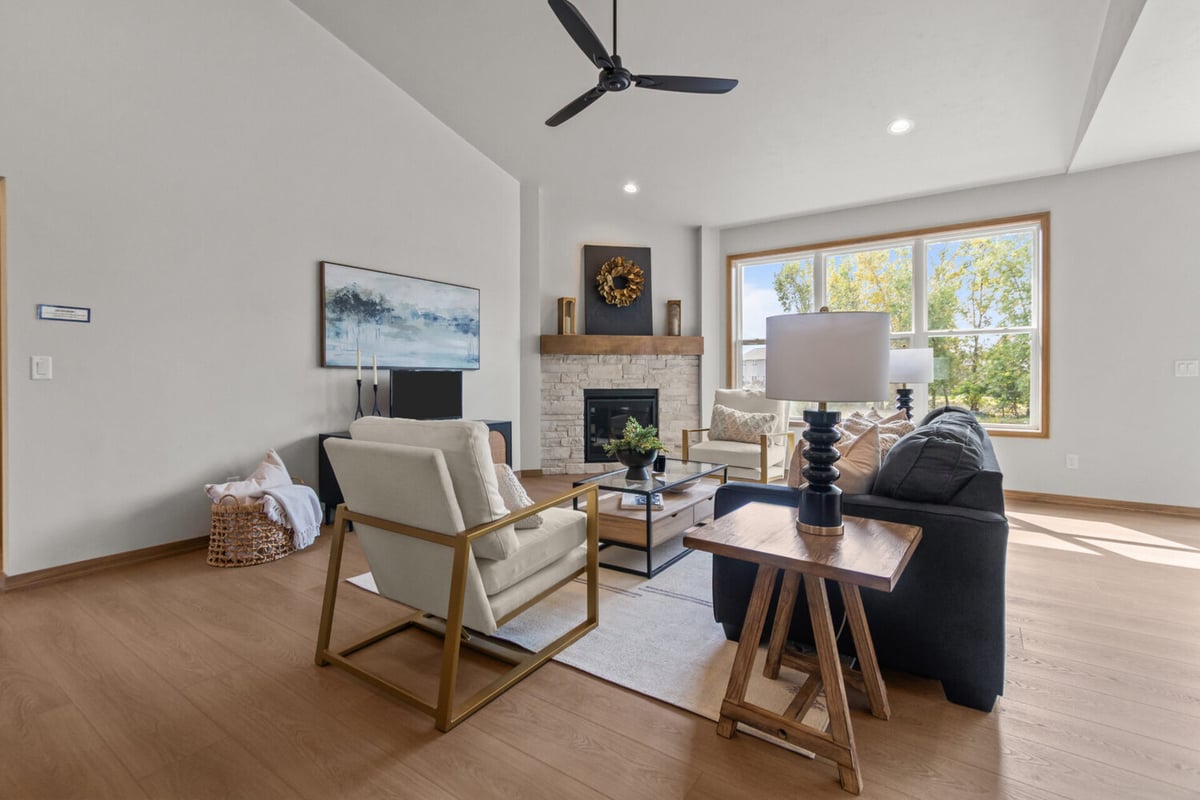 Custom-built living room with fireplace and large windows by Midwest Design Homes in Harrison, WI