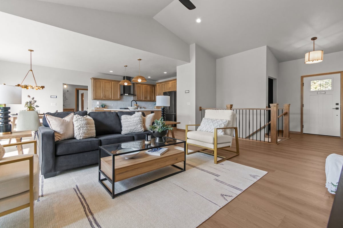 Custom-designed living room with sectional seating and view into kitchen by Midwest Design Homes in Ledgeview, WI