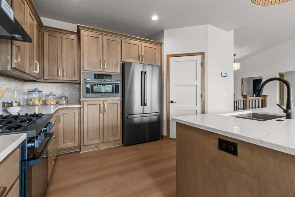 Functional kitchen corner layout featuring quartz countertops and ample cabinetry by Midwest Design Homes