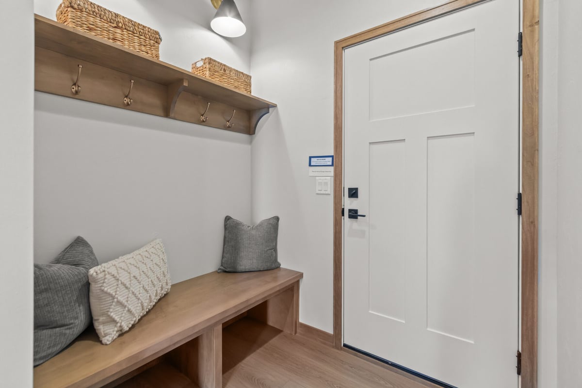 Functional mudroom with wood accents and cubbies in a Midwest Design Homes custom home in Appleton, WI