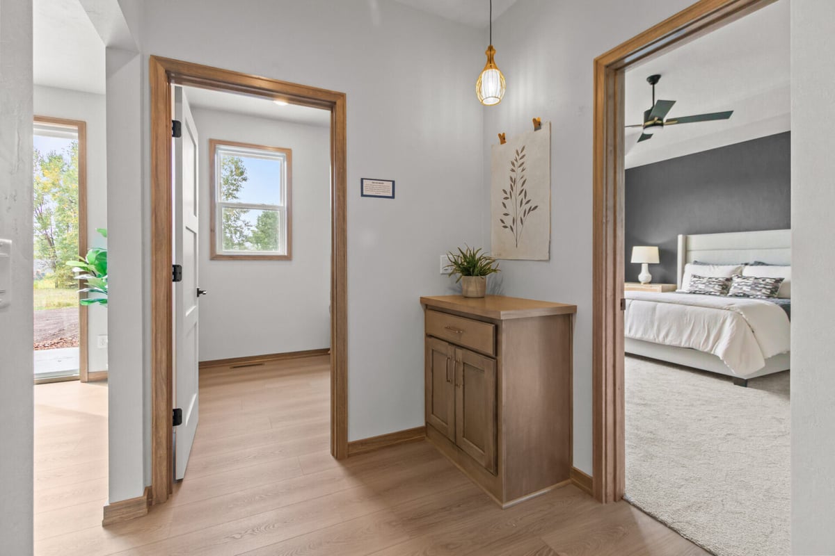 Hallway view connecting bedroom and laundry room in a custom home by Midwest Design Homes in Fox Cities, WI