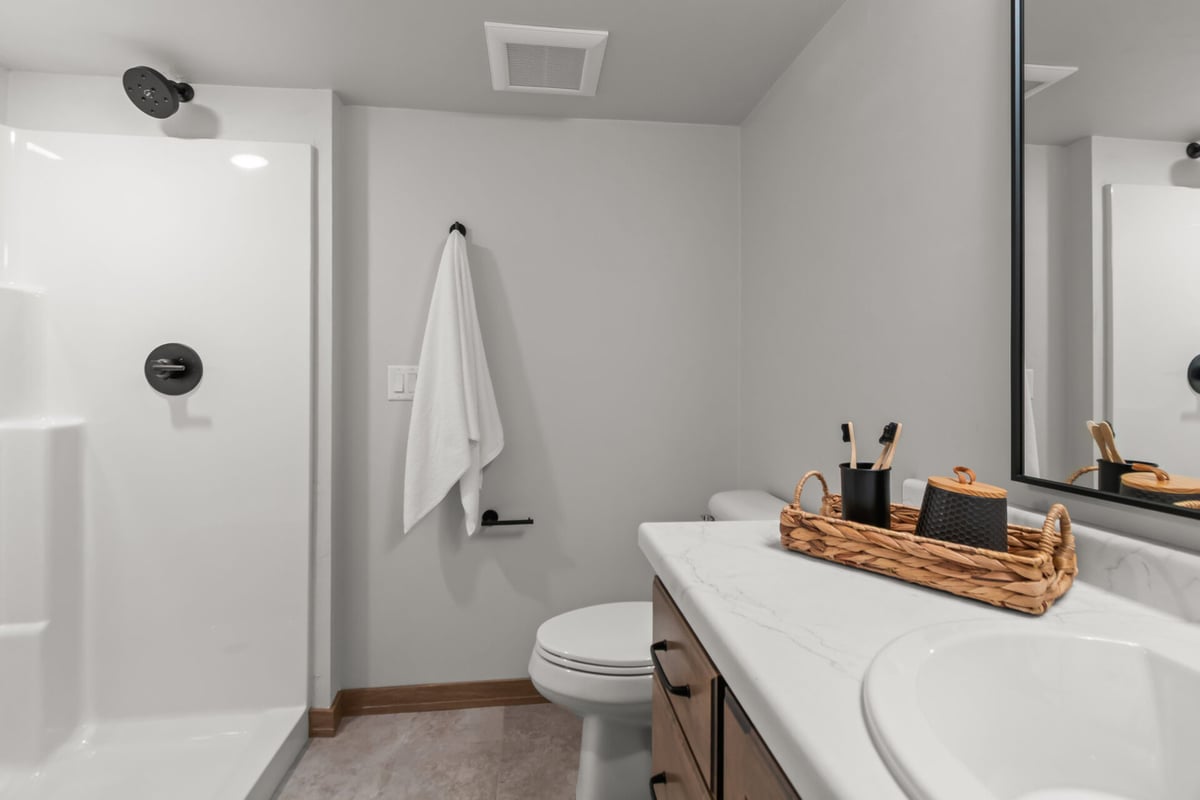 Modern walk-in shower and vanity area in a custom home bathroom by Midwest Design Homes in Kaukauna, WI