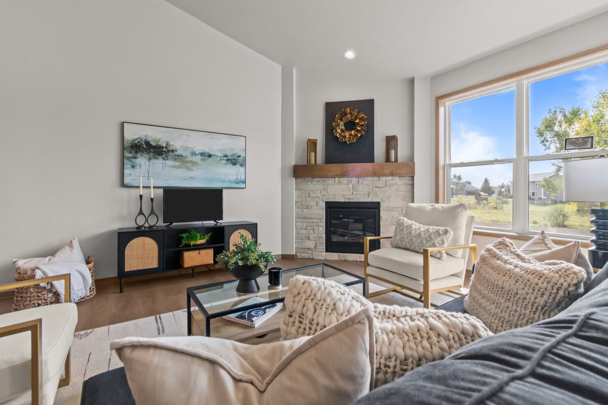 Stylish living room with fireplace and picture window in a Midwest Design Homes custom home in Fox Cities, WI