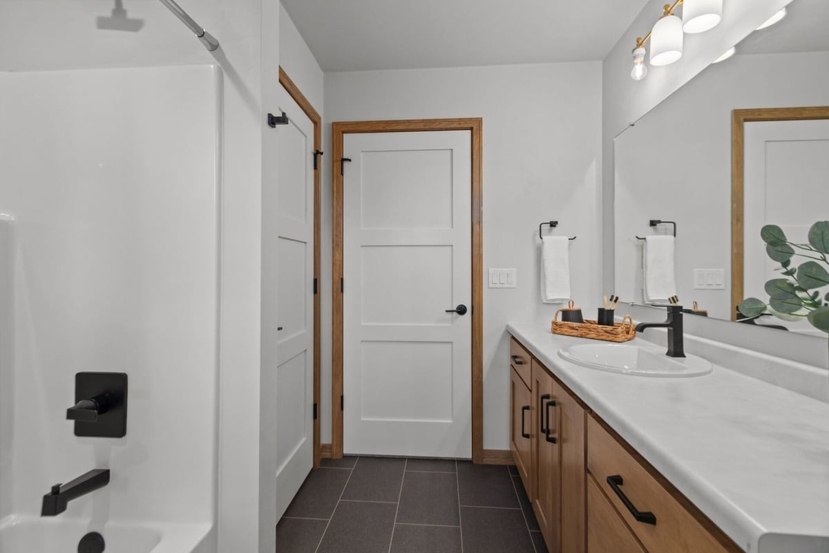 Custom bathroom with dual sinks and modern fixtures in a Kaukauna, WI home by Midwest Design Homes