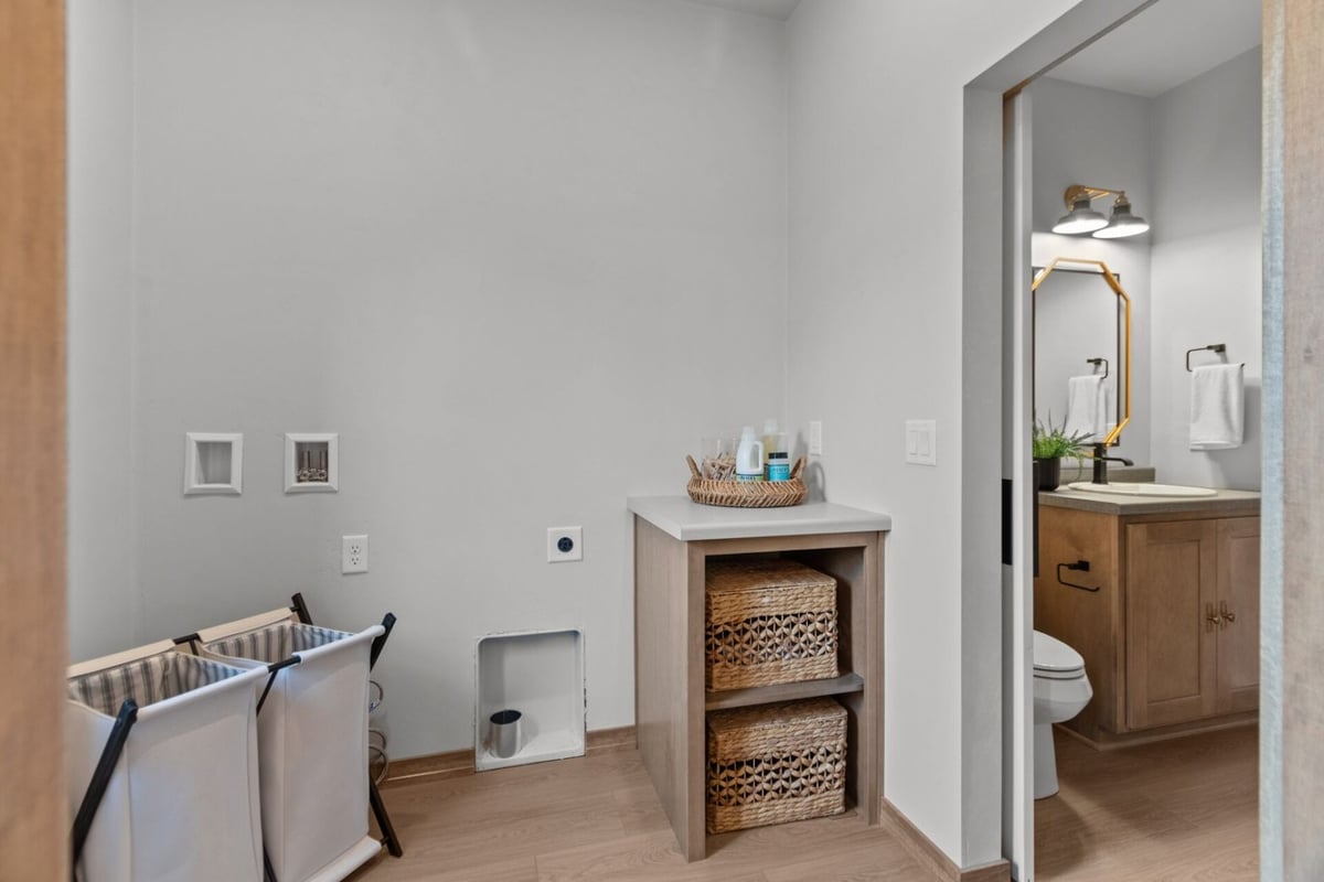Functional laundry space with built-in storage and adjoining half bath in an Appleton, WI custom home
