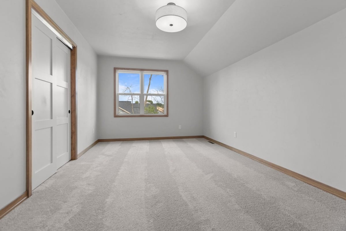 Interior bedroom space with multiple access points in a Neenah, WI home by Midwest Design Homes